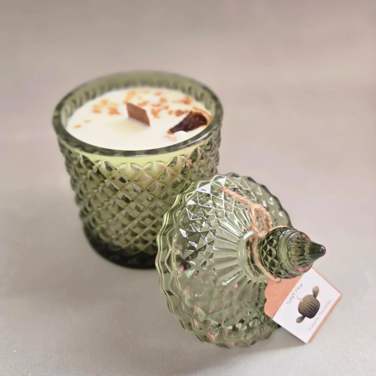 Vela aromática en recipiente decorativo en forma de joyero de gran tamaño para un quemado duradero. Disponible en los aromas Canela y Naranja (recipiente verde)  o Verbena (recipiente violeta).